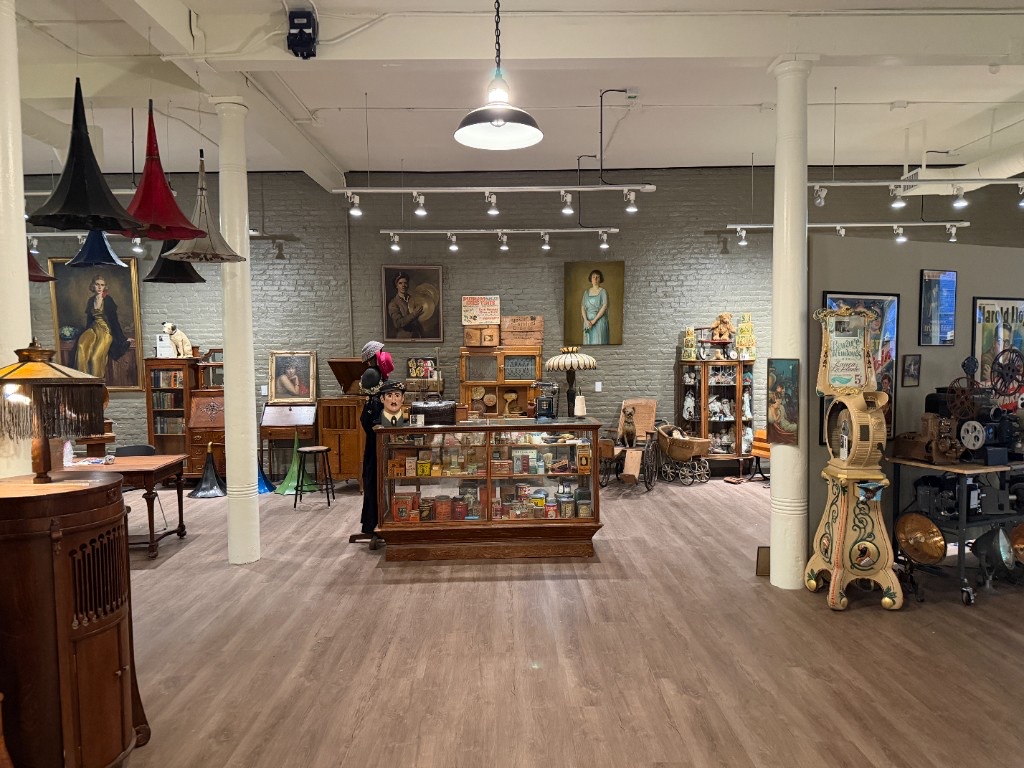 The main Beautiful Things room, with display cases and paintings