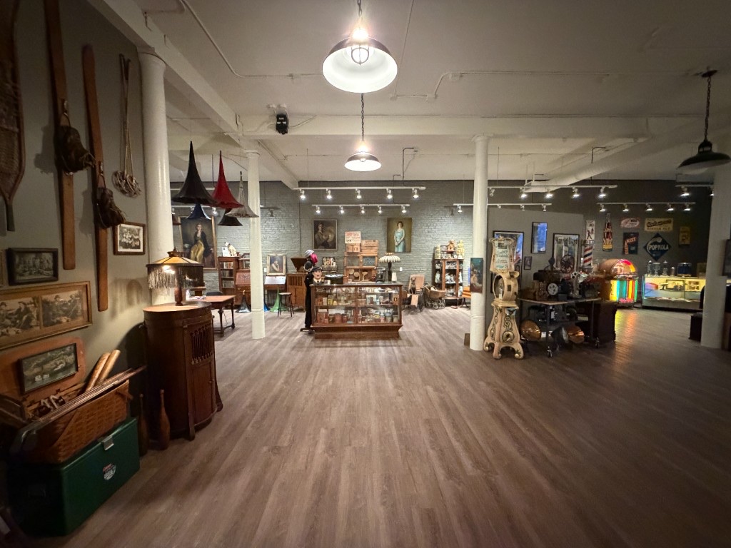 A long view of the gallery floor with glowing jukeboxes